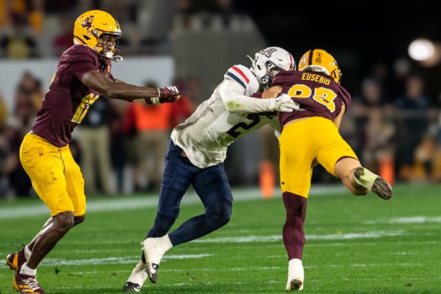 ASU Derek Eusebio being tackled by Wildcats Treydan Dukes